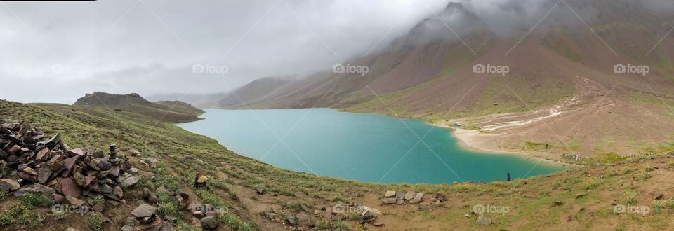 Emerald green lake surrounded by the Himalayas 
