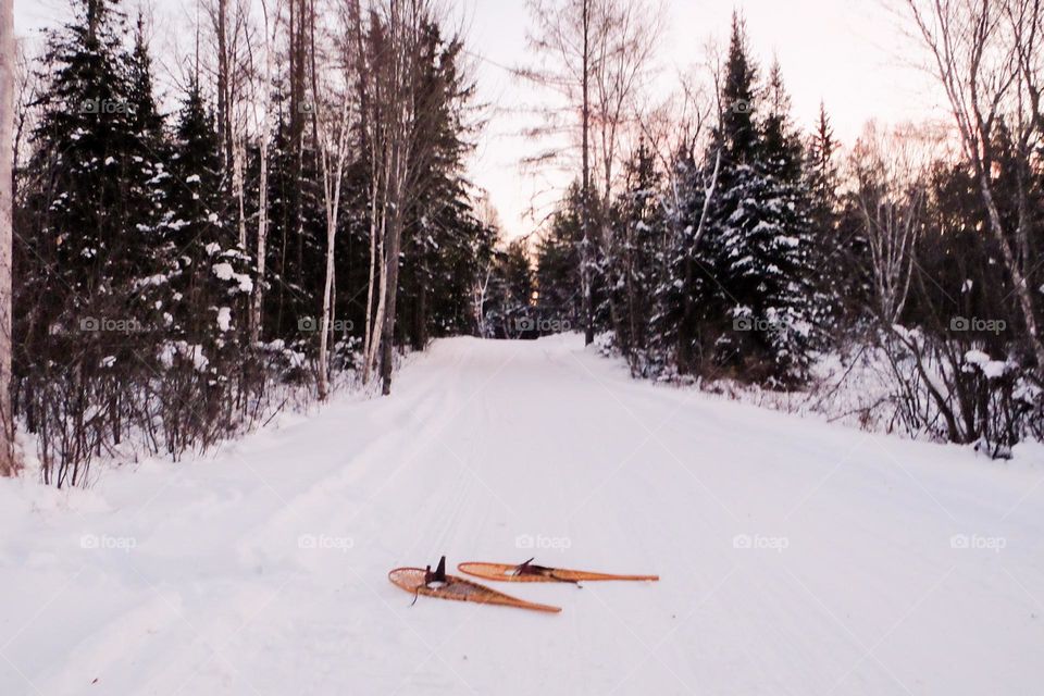 Northern Ontario Canada snowshoeing through frozen cold white snow on winter day