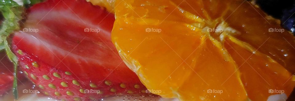 sliced strawberry and orange . healthy snacks