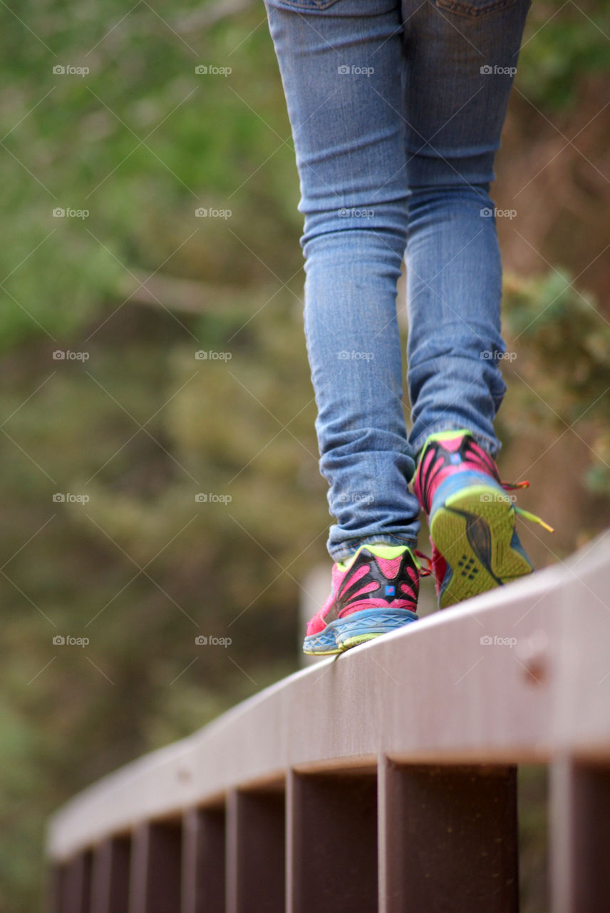 Child walking on the fence 