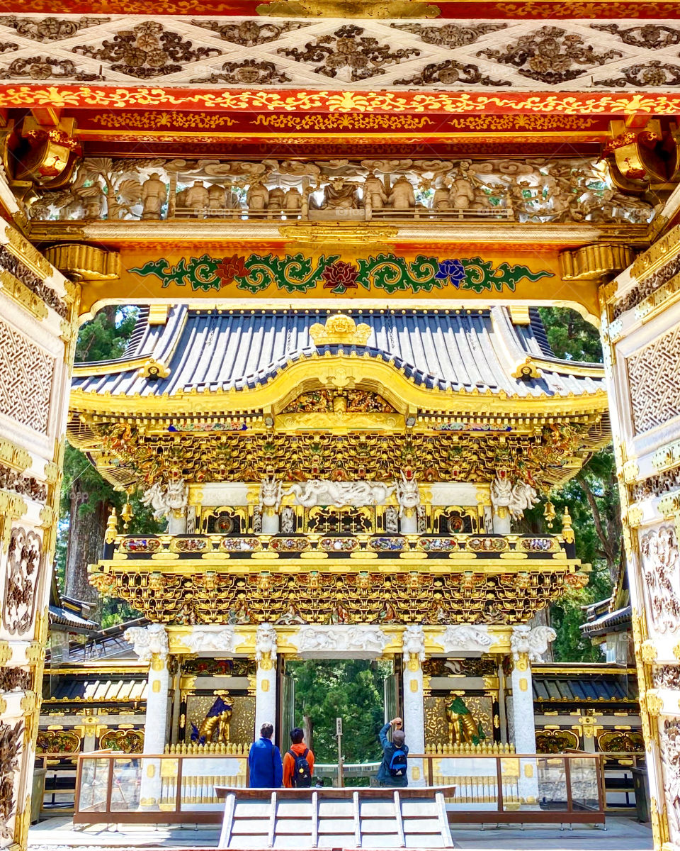 Glitzy gold gilded woodwork carvings on the main gates at Toshogu shrine in Nikko, Japan.