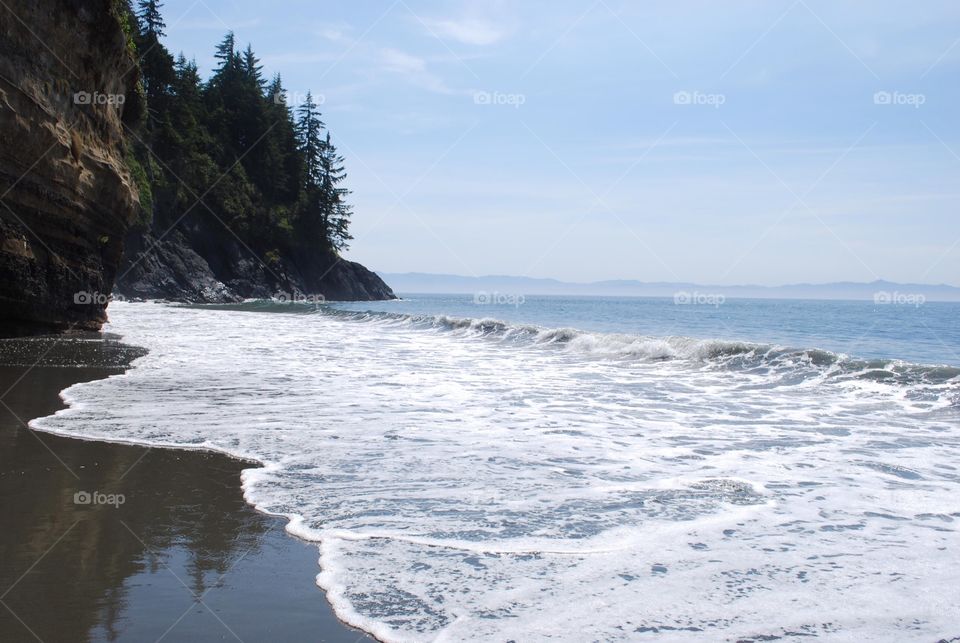 Scenic view of cliff by sea