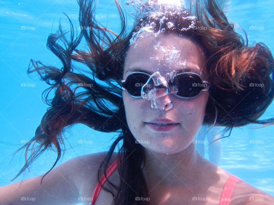 Close-up of a woman swimming under water