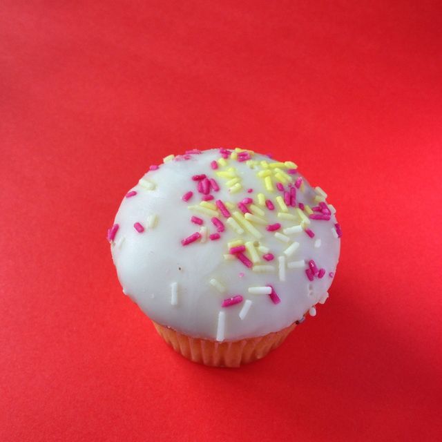 Cupcake. A white cupcake on a red background