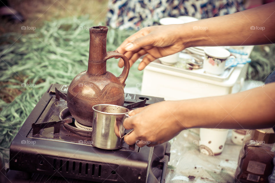 Fresh burned coffee beans. Iternational BBQ. Friend from Eritrea prepare for us coffee with a traditional coffee drinking culture.