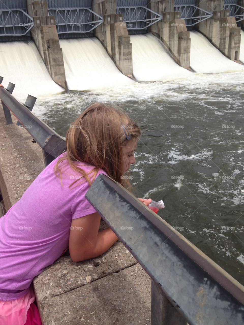 Girl adventure . Girl watching water released from Lavon dam