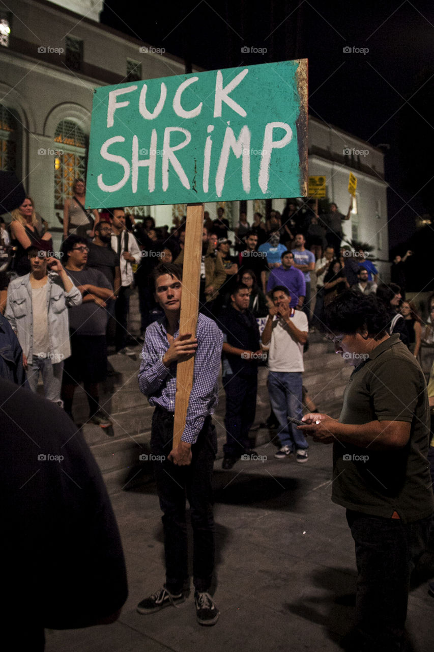 Man protesting shrimp at the steps of Los Angeles City Hall