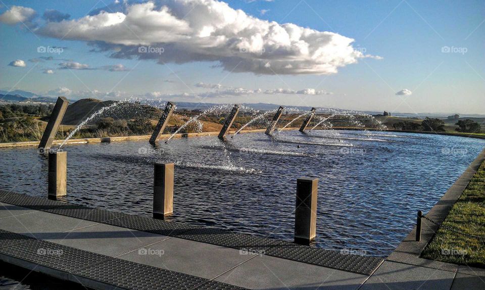 Fountain in a row at pond in the park