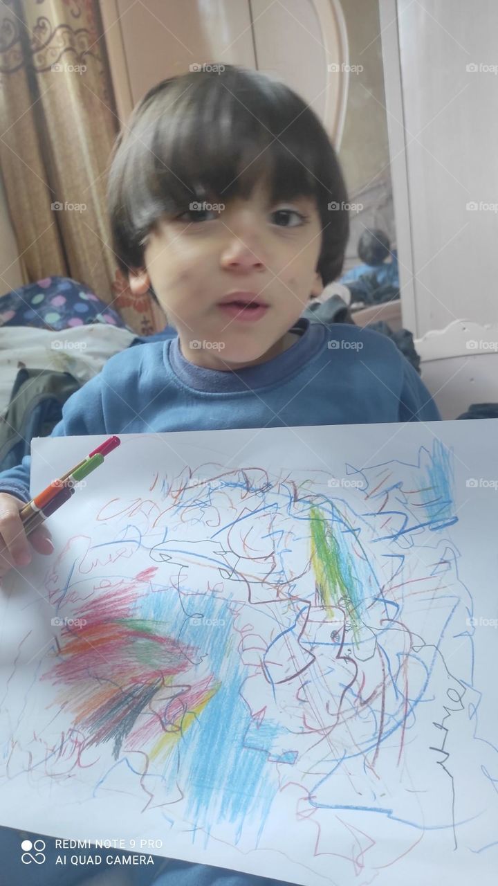 This child drew a beautiful picture, but he also painted a face