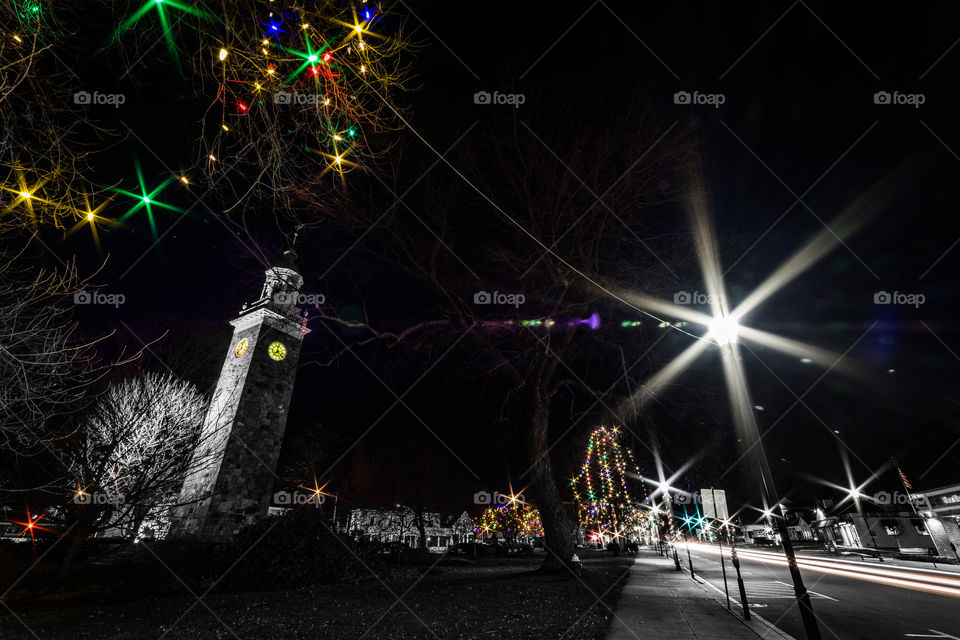 Was doing some street photography in Wellesley, MA by a clock tower after shooting a music video for a friend. Decided to do selective colors to make the image black and white and have the Christmas lights, the clock, & reflections in color. 