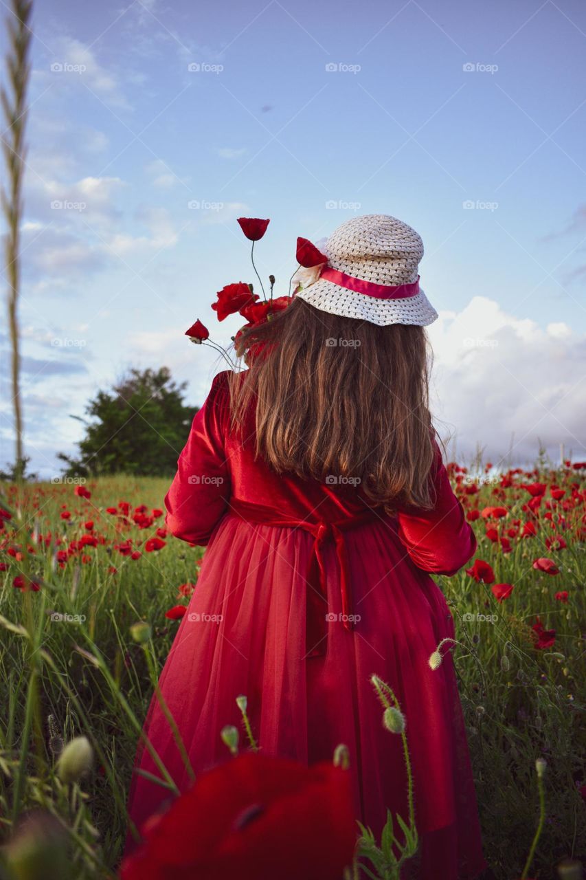 The girl in the red poppy fields 