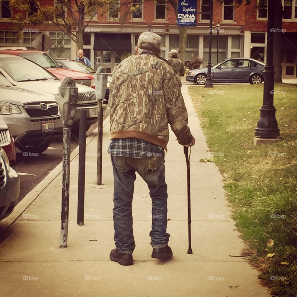 Waiting until he can get twelve dollars to purchase a prescription, this man walks on his cane and deals with his struggle as best he knows how. 