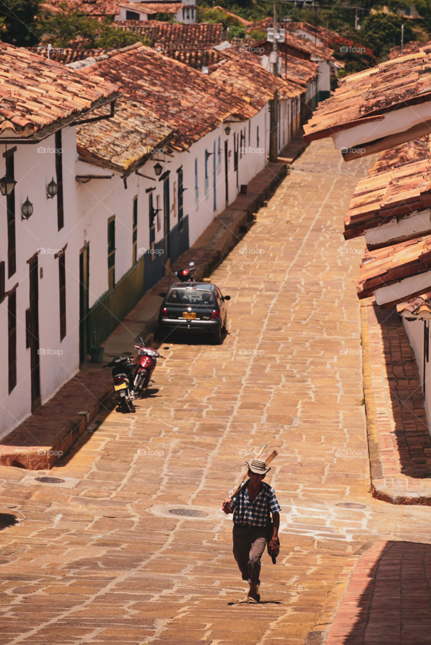 A man walking on the street in a colombian little town called Barichara