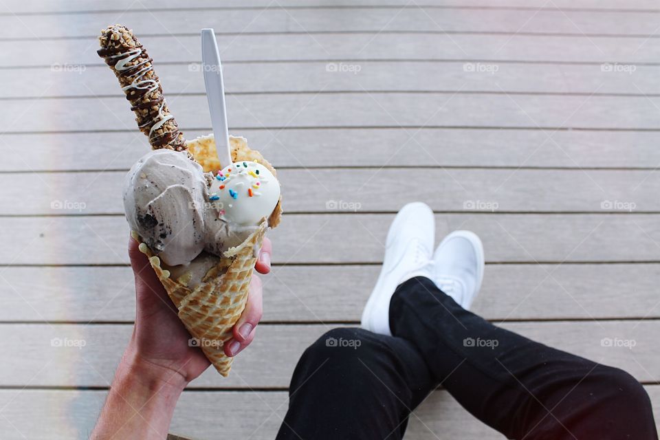 Elevated view of hand holding ice cream cone