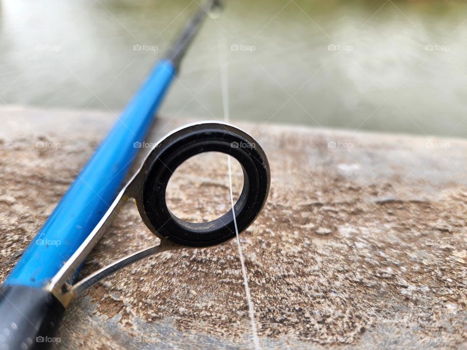 fishing rod eye with line running through it