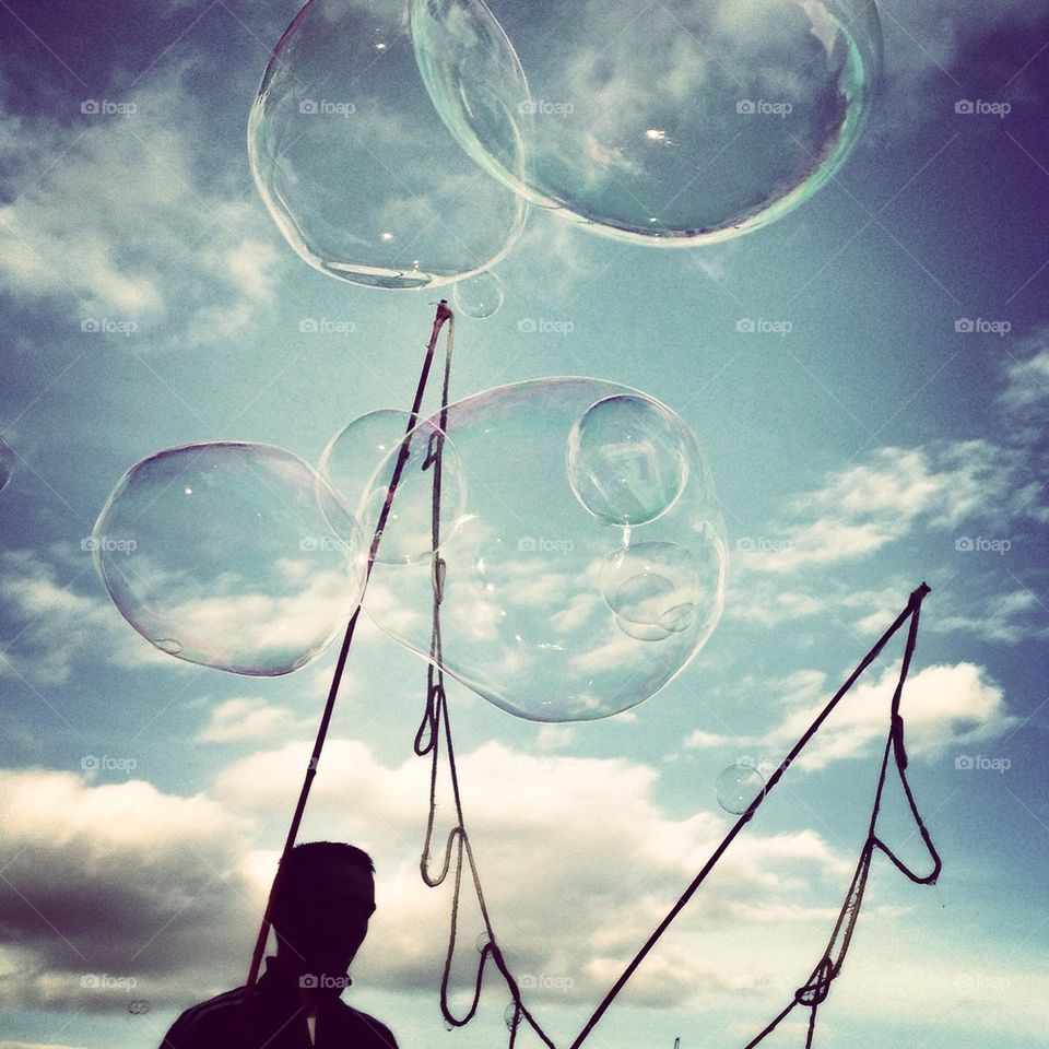 silhouette of a man with bubble wand