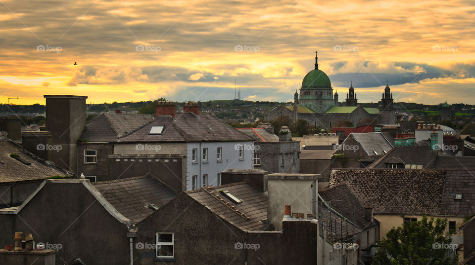 Galway cityscape at beautiful orange sunset with Cathedral in the background