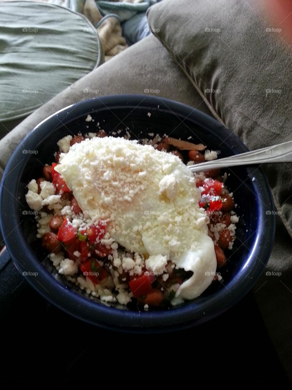 rice and beans with an egg, tomatoes and goat cheese. yummy breakfast