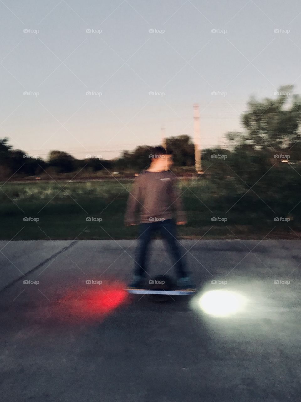 While taking pictures this young boy comes zooming by me on street surrounding the lake. Made a few passes so I decided to make this fast scooter part of my photos. 