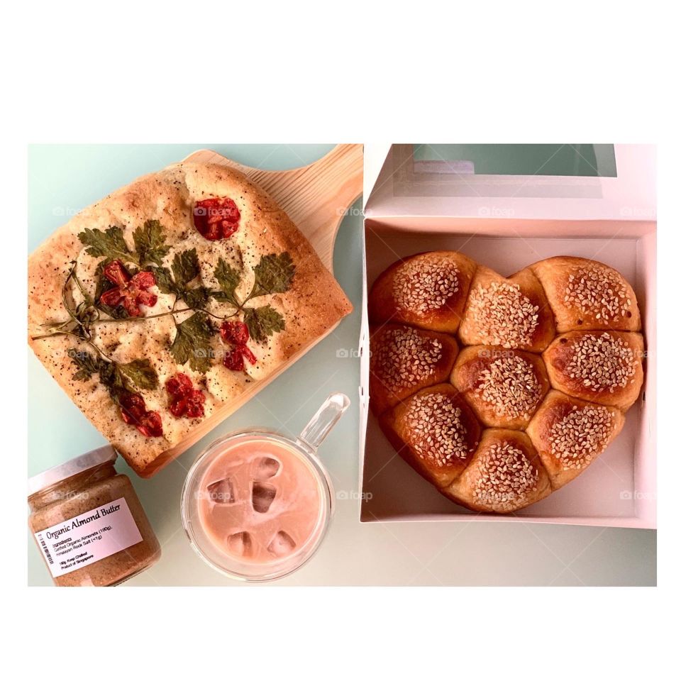 Wholesome healthy treats consisting of foccacia , heart shaped tomato cheese buns, almond butter for afternoon tea snack