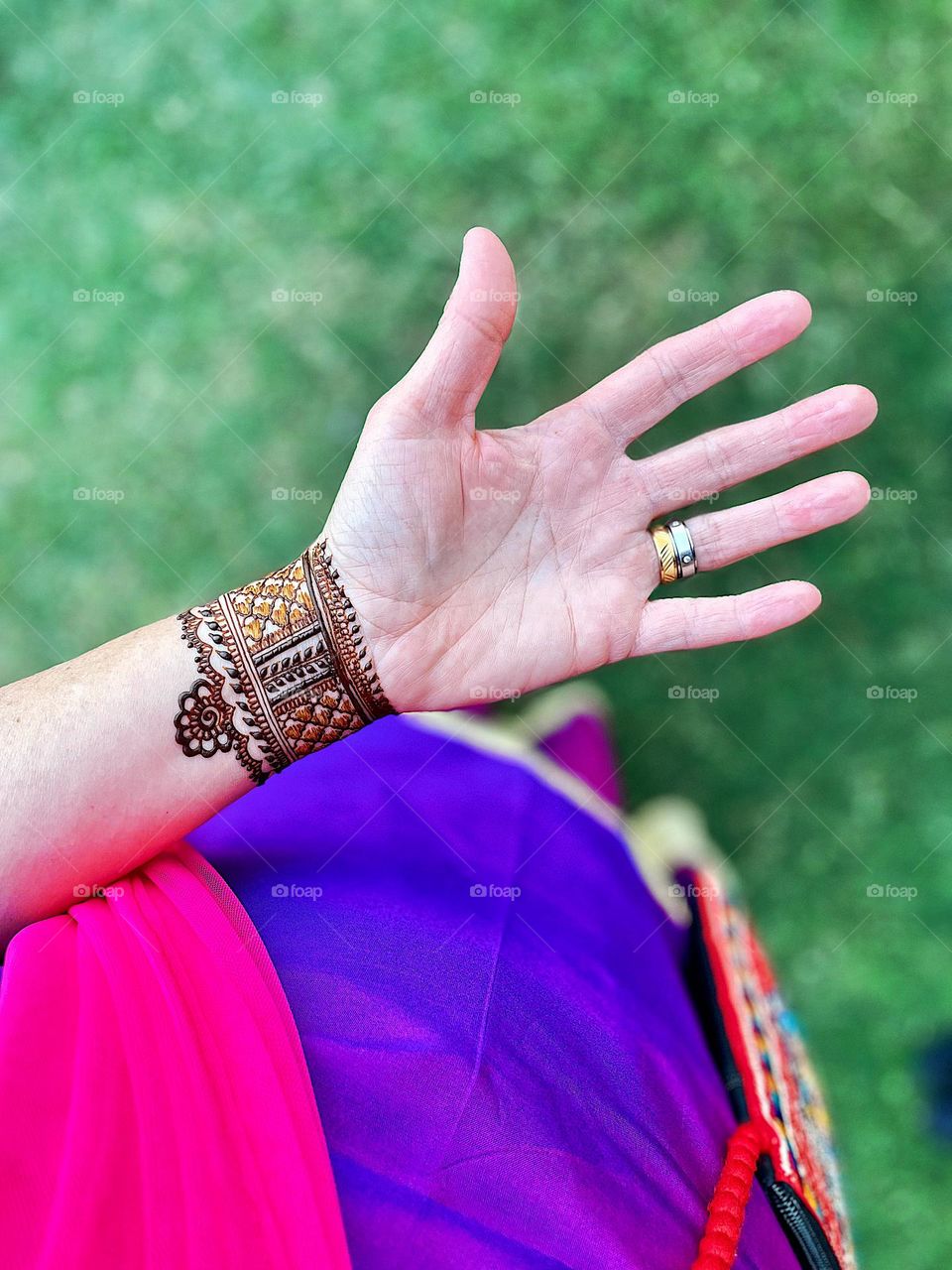 Woman at Indian wedding, mandhi at Indian wedding, woman’s hand at Indian wedding, colorful culture of India