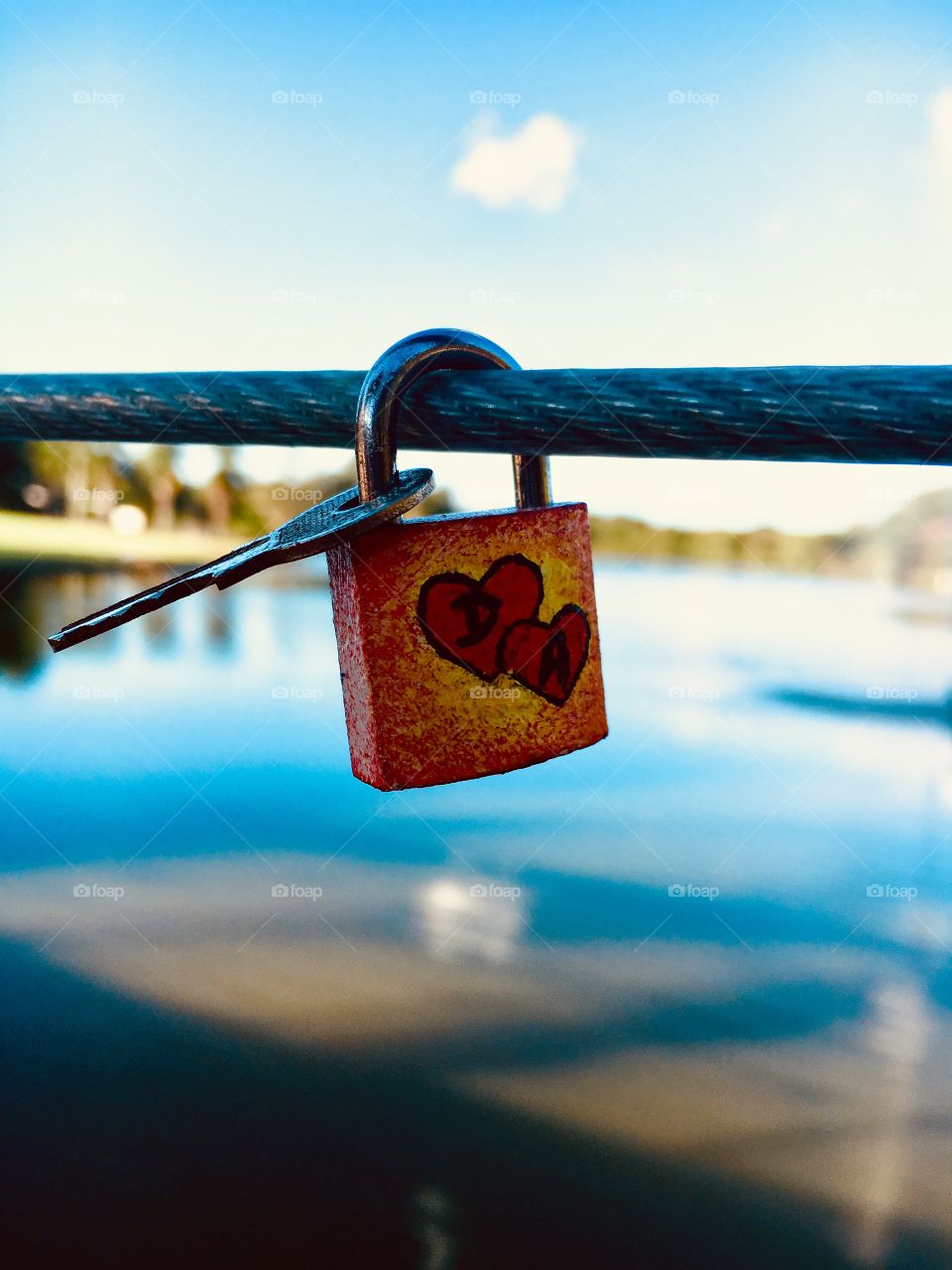 Love lock and key over the lake 