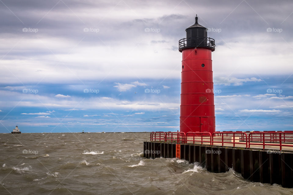 Red lighthouse in WI. Red light house at the end of a pier on Lake Michigan in Milwaukee Wisconsin