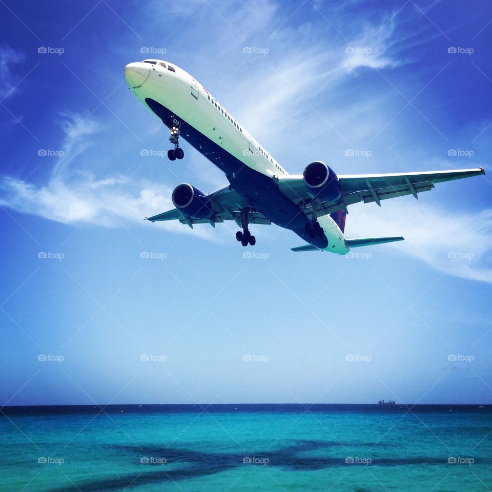 Plane Flying Over Caribbean Island, Plane Landing Over Maho Beach, Plane In The Sky, Plane With Shadow Over The Water, Flying On A Plane 