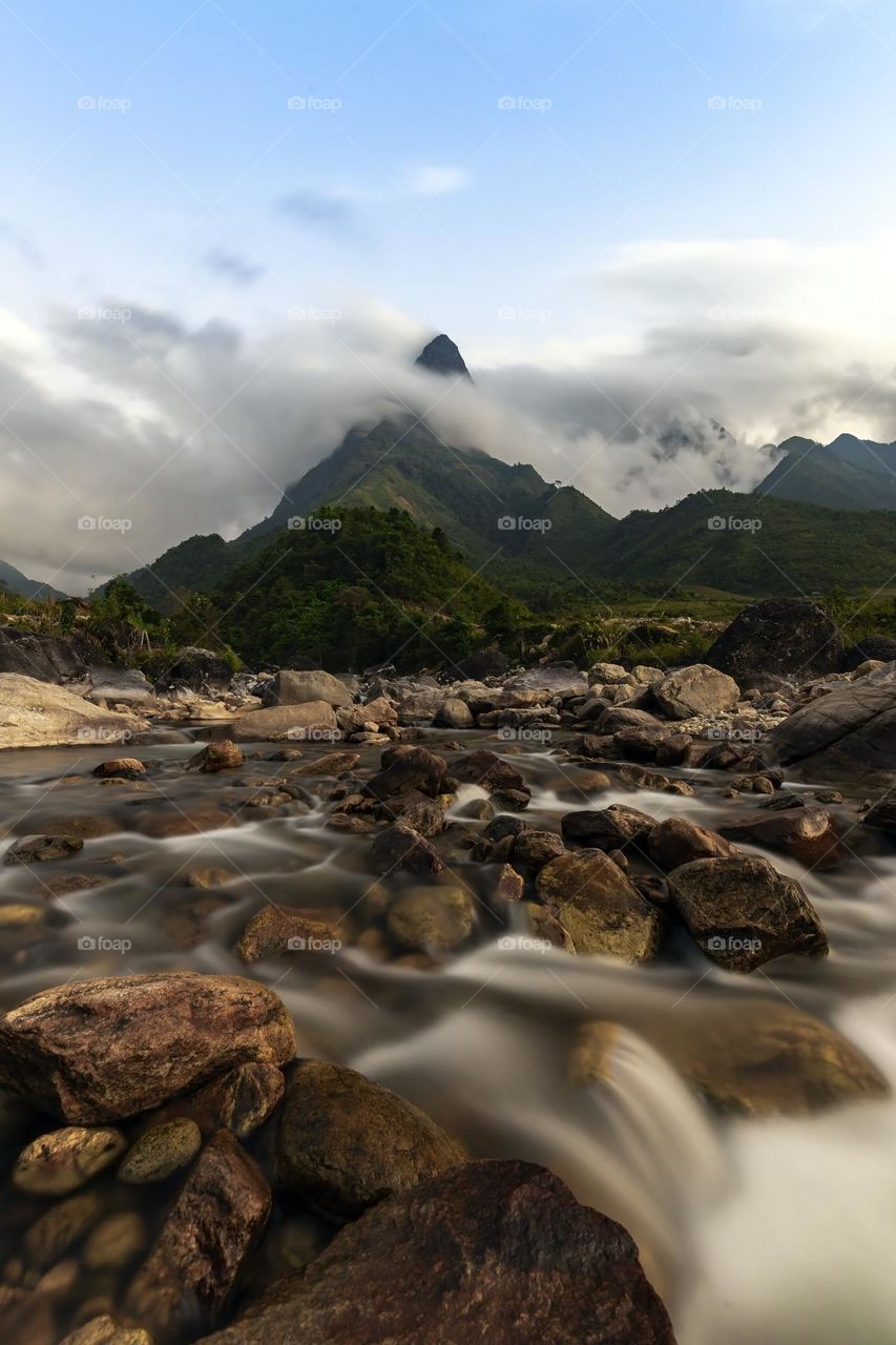 Chu Va mountain Peak with longexposure stream foreground and rocks