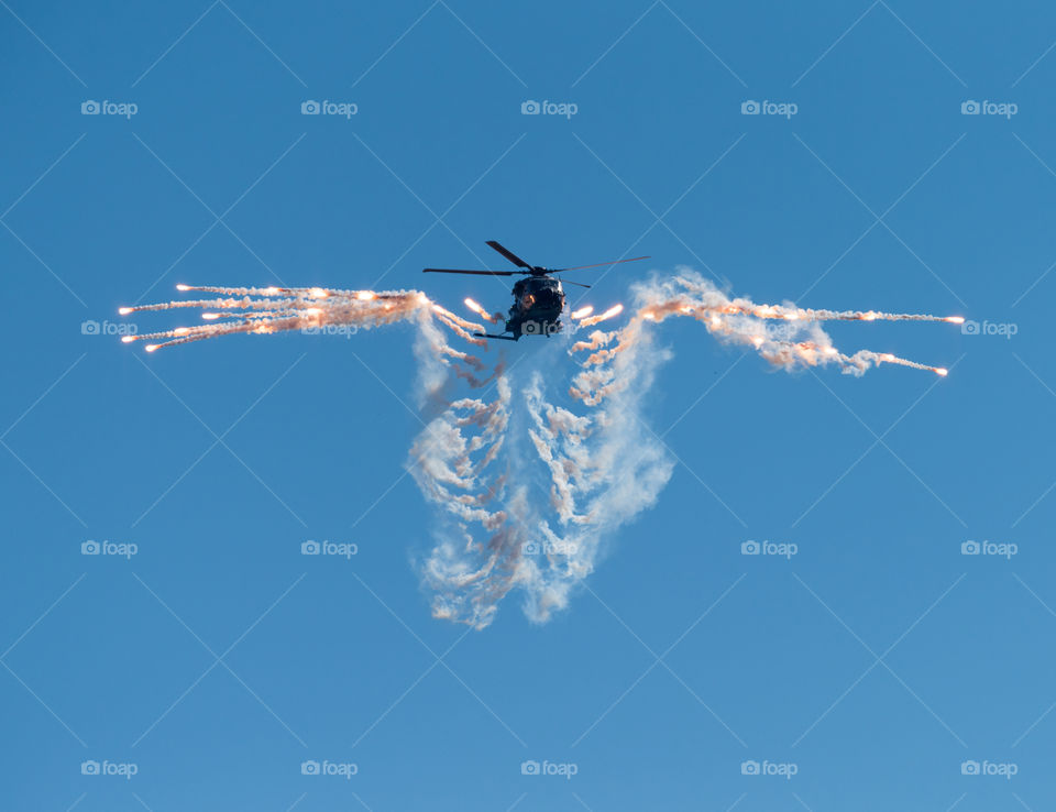 Helsinki, Finland - 9 June 2017: Finnish Army NH90 helicopter shooting out flares at the Kaivopuisto Air Show in Helsinki, Finland on 9 June 2017.