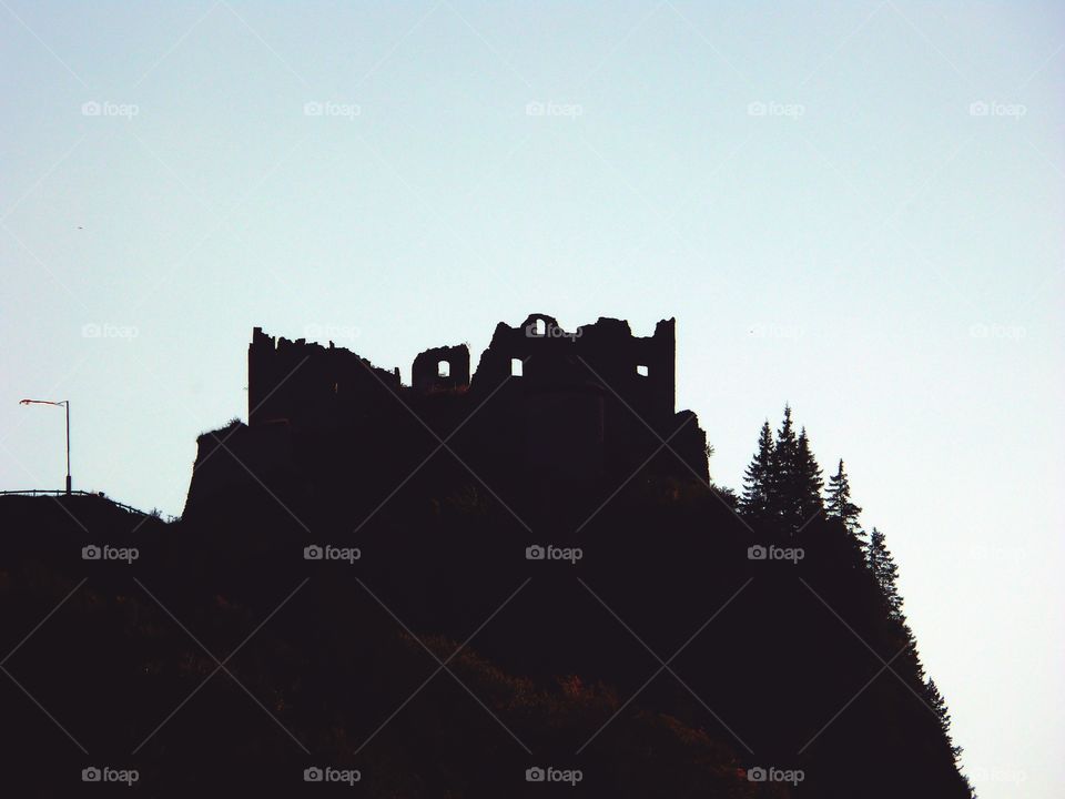 Low angle view of silhouette of a castle ruin on top of hill in Tyrol, Austria.