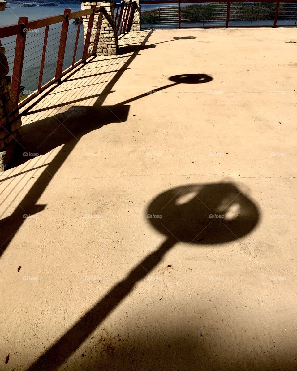 Shadows of tower viewer scopes on balcony overlooking Lake Guntersville 
