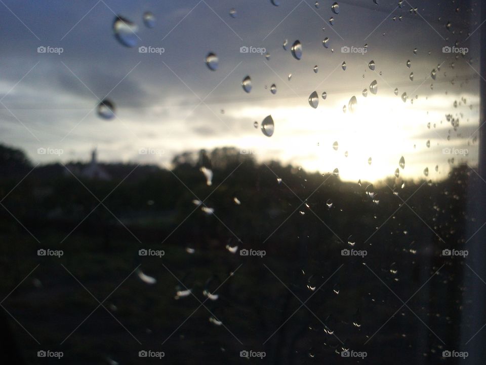 Raindrops in the window at dusk