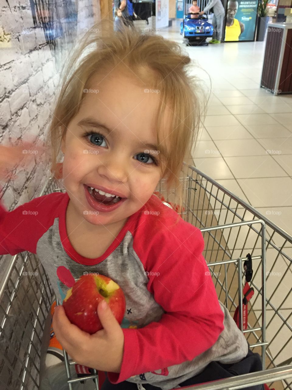 Smiley girl holding apple