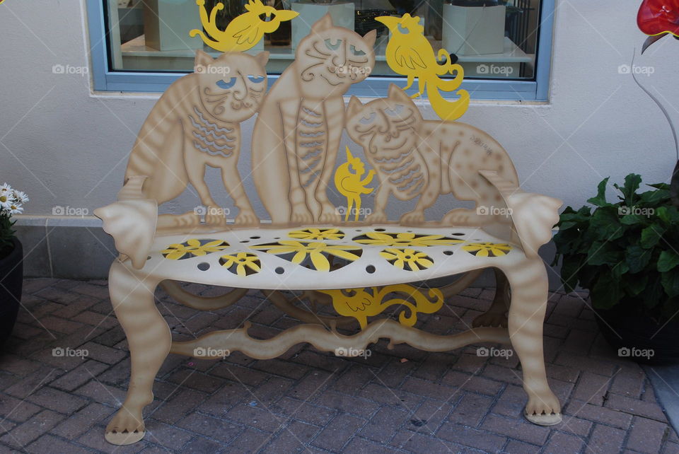 Yellow bench in front of a store