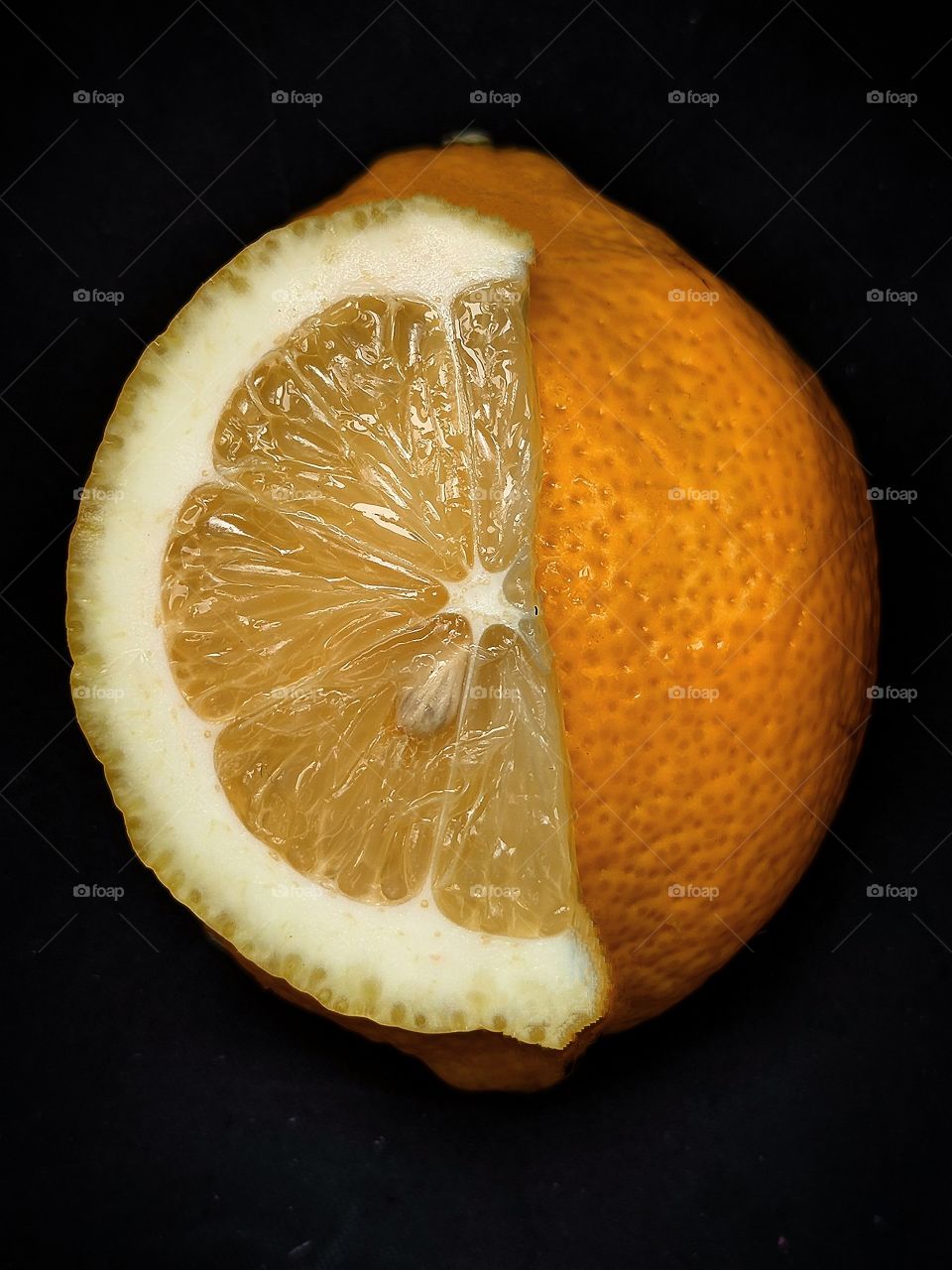 lemon and lemon slice on black background