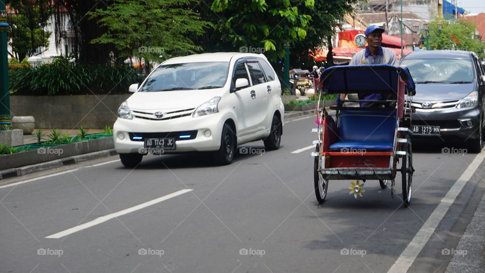 Becak is a three-wheeled transportation mode commonly found in Indonesia and also in parts of Asia. The normal capacity of a pedicab is two passengers and a driver.