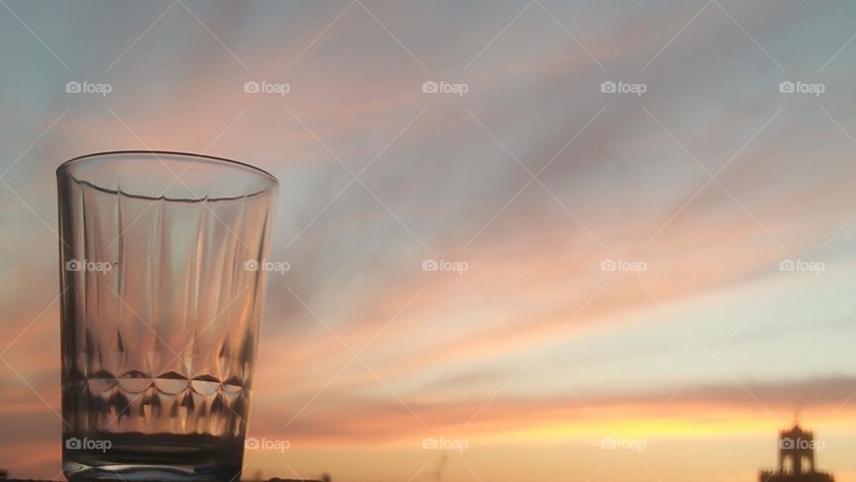 A glass hugs the glamour of sunset.