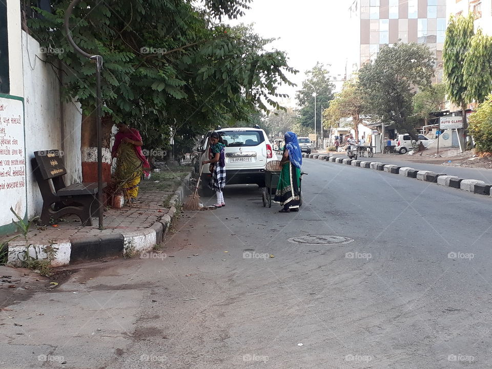 Women clearing the road in the morning