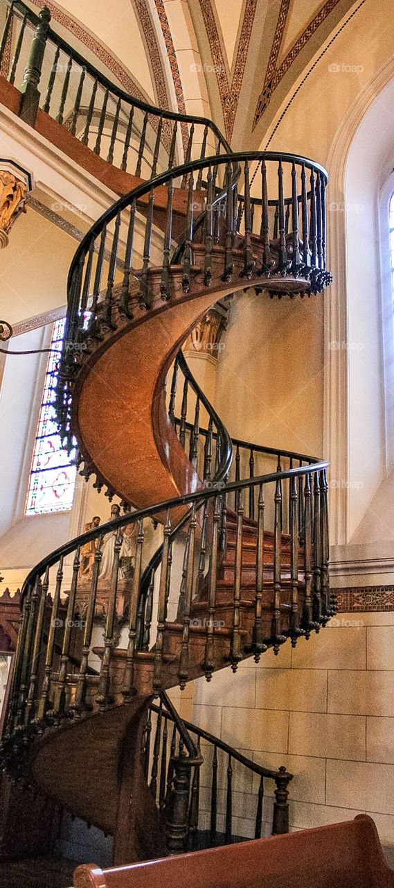 Built in the 1800's for the sisters of the Loretto chapel by a carpenter, hand crafted and molded with warm water to create a double helix with no center support held together by wood pegs with no glue or nails 