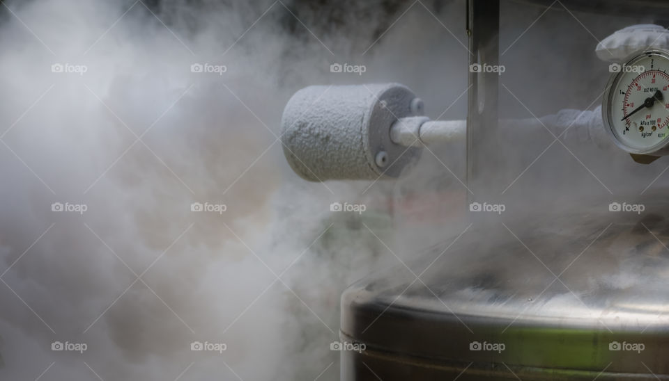 Excess smoky nitrogen gas discharge during filling of a liquid nitrogen dewar.