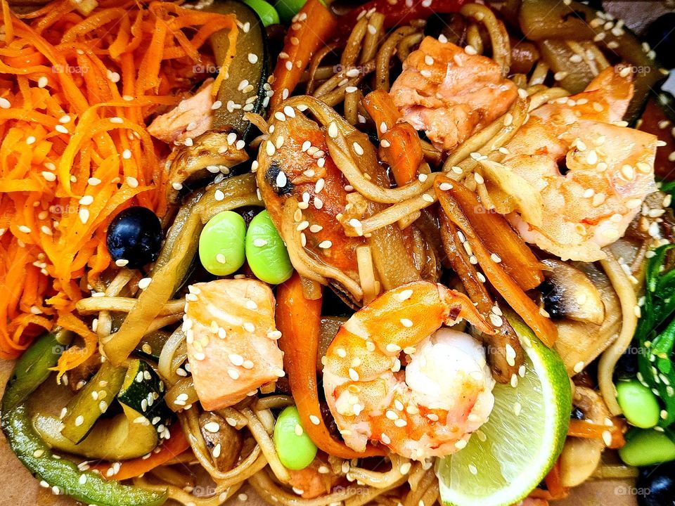 colorful top view of wok baked vegetables with mussels and other seafood