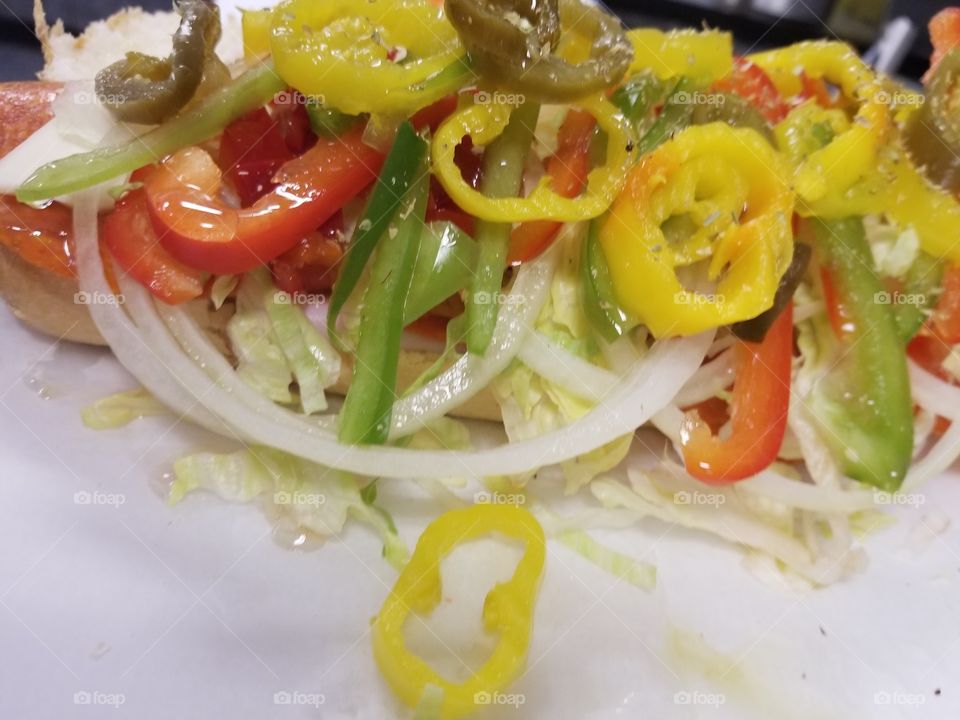 the construction of the world's best spicy Italian sub. Delicious!!