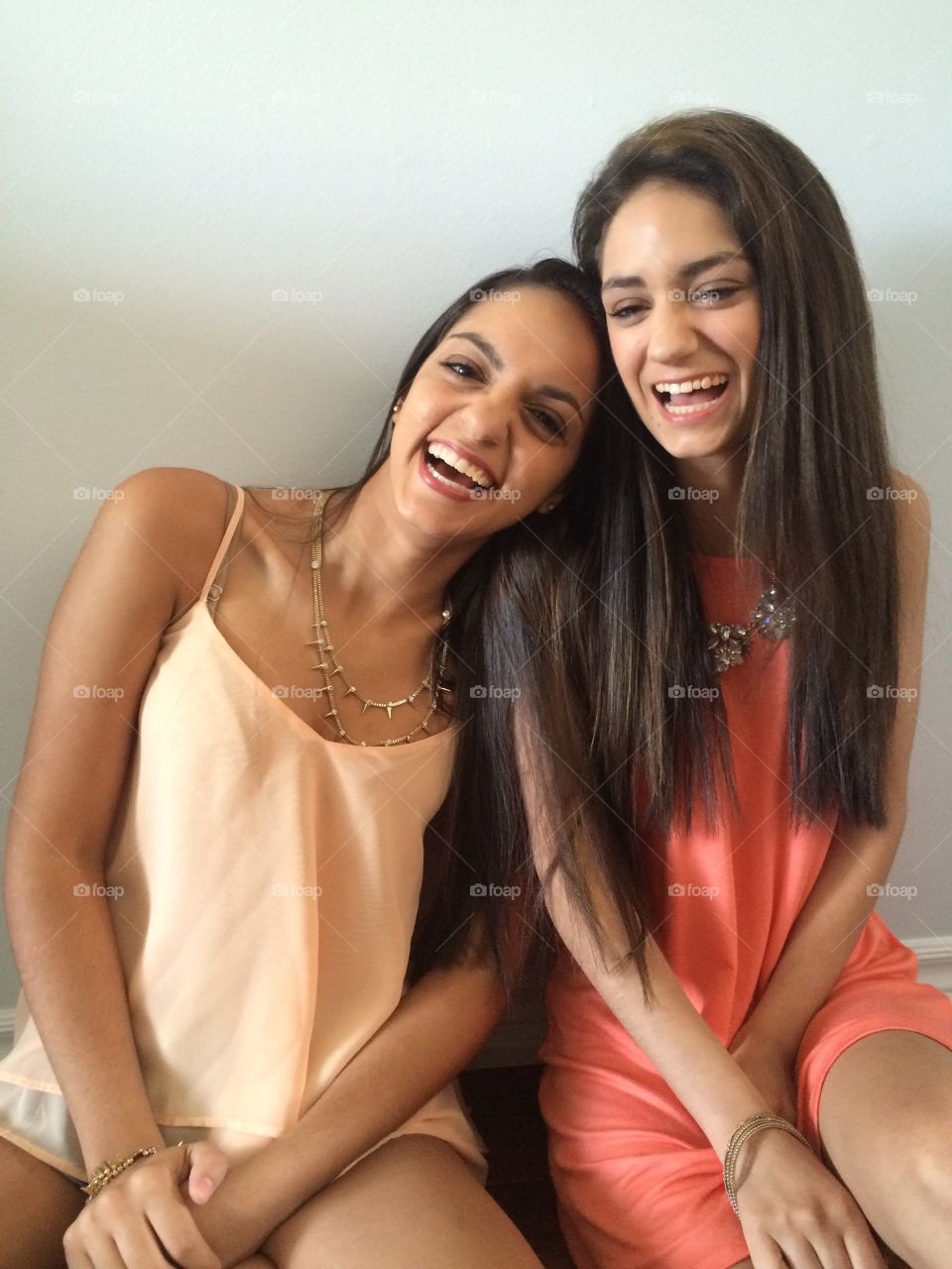 Two sisters laughing a joke 