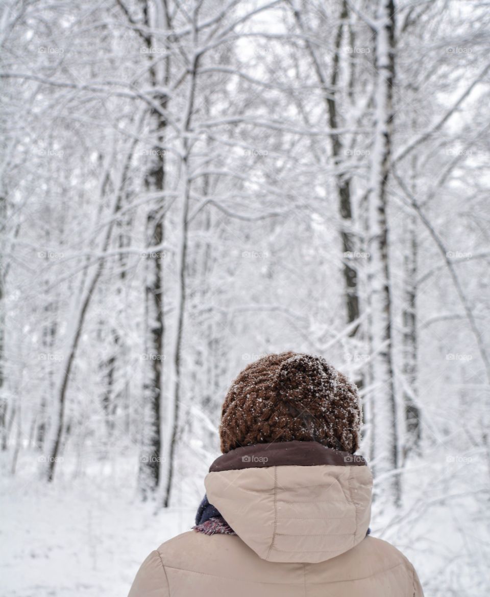 sweater weather woman walking in snowy park winter time