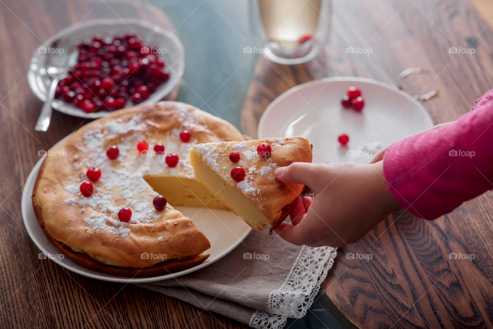 Children breakfast with cheesecake. Hands, detail