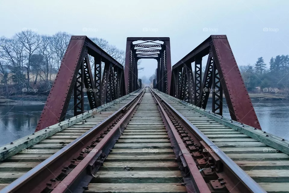 “The Crossing”.  A trestle bride beckons passage across a river on a misty, atmospheric evening.