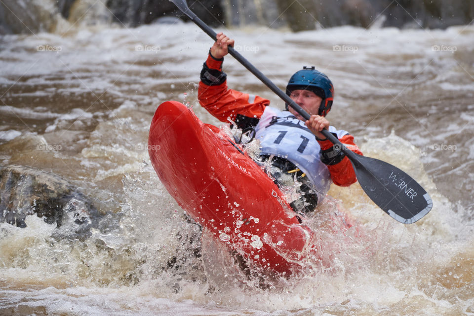 Helsinki, Finland - April 15, 2018: Unidentified racer at the annual Icebreak 2018 whitewater kayaking competition at the Vanhankaupunginkoski rapids in Helsinki, Finland.