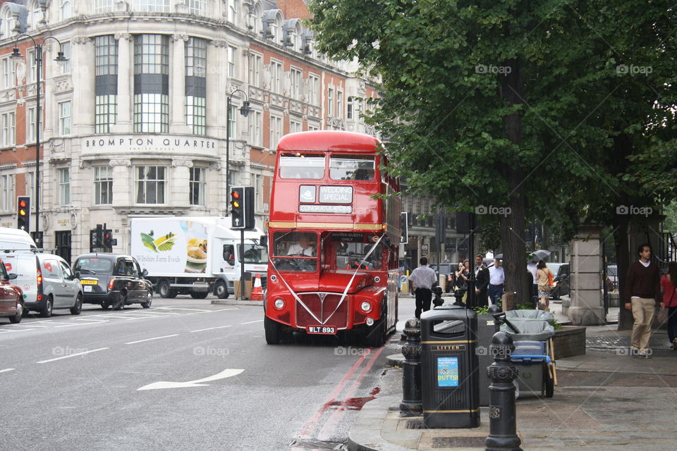 Look at this grand red double decker bus on the London streets. 