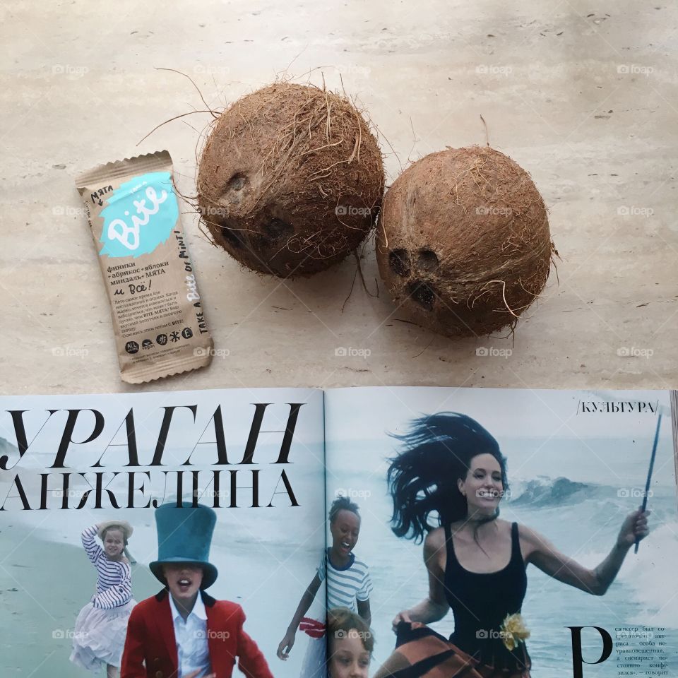 Composition of magazine and coconut food bite delicious 
